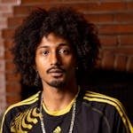 Portrait of a stylish man with afro hair in São Paulo, highlighting urban fashion.